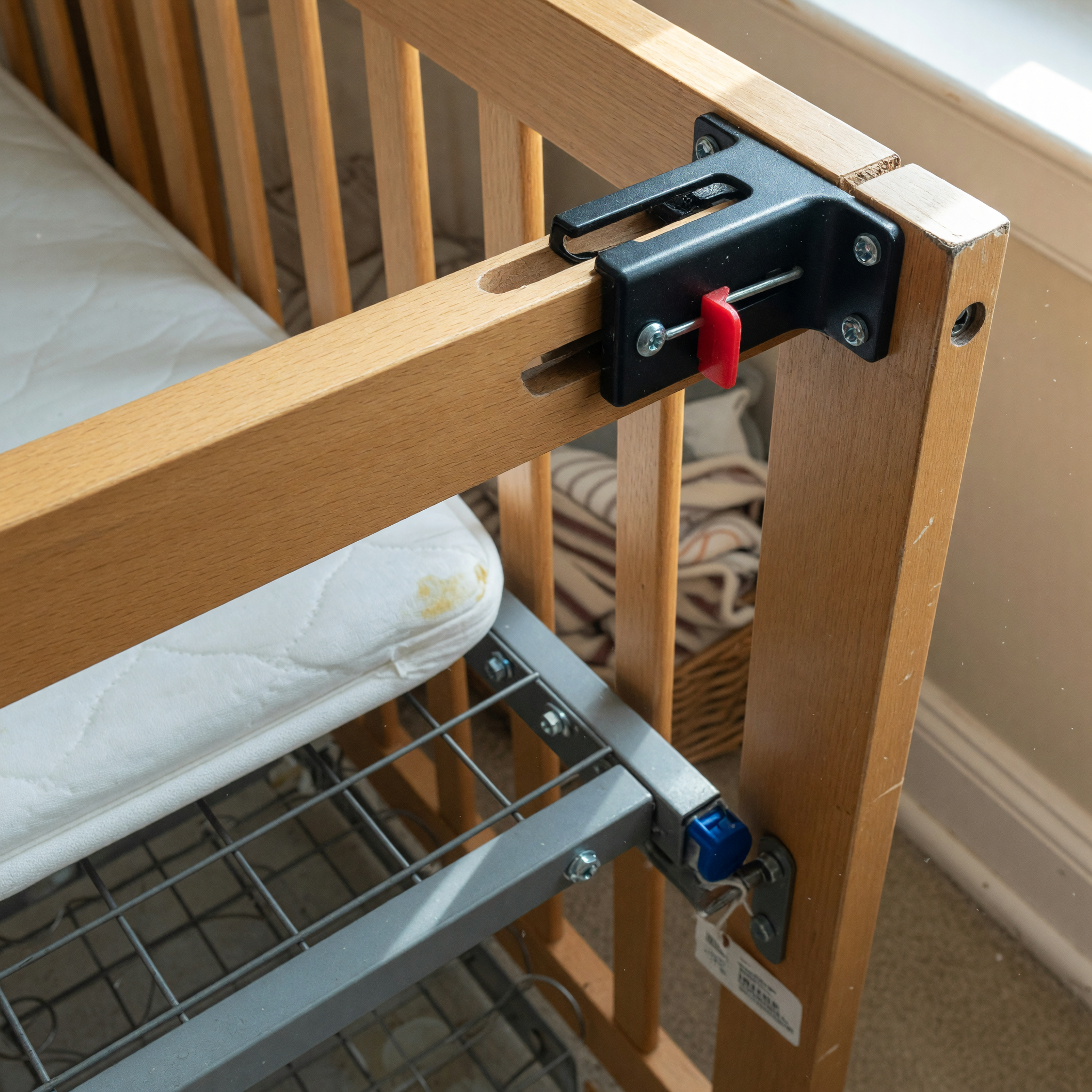 Close-up view of crib hardware and support details